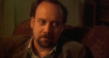 Movie still from “Sideways” (2004), directed by Alexander Payne – A person sitting in a chair looking at the camera; Close Up shot, Over the shoulder angle