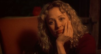 Movie still from “Sideways” (2004), directed by Alexander Payne – A woman sitting in a chair with her hand on her face; Close Up shot, Over the shoulder angle