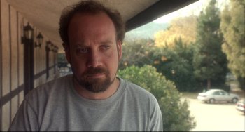 Movie still from “Sideways” (2004), directed by Alexander Payne – A man with a goatee is looking out a window; Close Up shot, Low angle