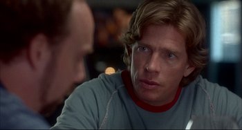 Movie still from “Sideways” (2004), directed by Alexander Payne – A man sitting in front of another man in front of a window; Close Up shot, Over the shoulder angle