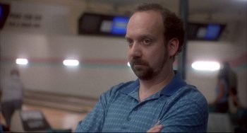 Movie still from “Sideways” (2004), directed by Alexander Payne – A man in a blue shirt with his arms crossed; Close Up shot, Low angle