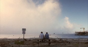 Movie still from “Sideways” (2004), directed by Alexander Payne – Two people sitting on a bench looking out at the ocean; Extreme Wide shot, Low angle