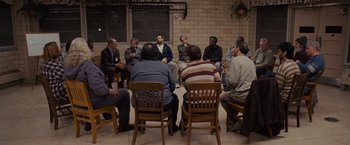 Movie still from “Silver Linings Playbook” (2012), directed by David O. Russell – A group of people sitting in a circle; Wide shot, High angle