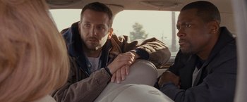 Movie still from “Silver Linings Playbook” (2012), directed by David O. Russell – A man sitting in the back seat of a car; Close Up shot, Over the shoulder angle