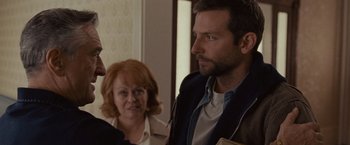 Movie still from “Silver Linings Playbook” (2012), directed by David O. Russell – A man and a woman talking to another man; Close Up shot, Over the shoulder angle