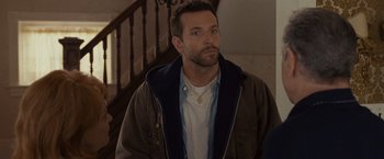 Movie still from “Silver Linings Playbook” (2012), directed by David O. Russell – A person standing near a staircase; Close Up shot, Over the shoulder angle