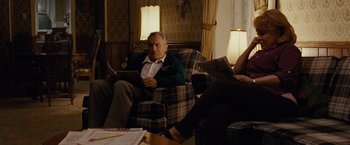 Movie still from “Silver Linings Playbook” (2012), directed by David O. Russell – An older man sitting on a chair in a living room; Medium shot, Over the shoulder angle