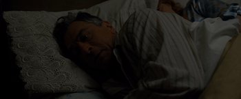 Movie still from “Silver Linings Playbook” (2012), directed by David O. Russell – A man laying in a bed with his head on a pillow; Close Up shot, Overhead angle