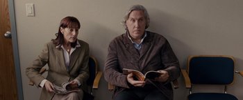 Movie still from “Silver Linings Playbook” (2012), directed by David O. Russell – A man and a woman are sitting in a waiting room; Medium shot, Over the shoulder angle