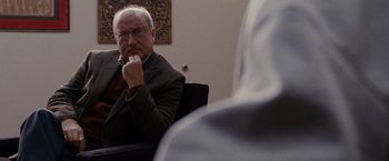 Movie still from “Silver Linings Playbook” (2012), directed by David O. Russell – An older man sitting in front of another man in a chair; Close Up shot, Over the shoulder angle