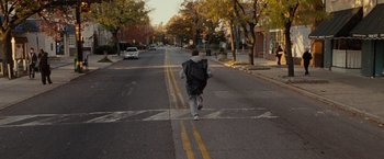 Movie still from “Silver Linings Playbook” (2012), directed by David O. Russell – A man running down the middle of the street; Wide shot, High angle