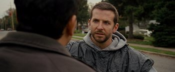 Movie still from “Silver Linings Playbook” (2012), directed by David O. Russell – A man in a hooded jacket talking to another man in a hooded jacket; Close Up shot, Over the shoulder angle