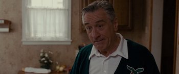 Movie still from “Silver Linings Playbook” (2012), directed by David O. Russell – An older man in a white shirt and a green sweater; Close Up shot, Over the shoulder angle