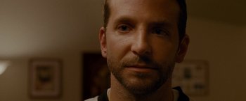 Movie still from “Silver Linings Playbook” (2012), directed by David O. Russell – A man's face in a dark room; Close Up shot, Over the shoulder angle