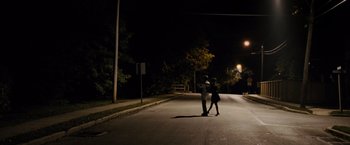 Movie still from “Silver Linings Playbook” (2012), directed by David O. Russell – Two people walking down a street at night; Extreme Wide shot, Low angle