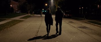 Movie still from “Silver Linings Playbook” (2012), directed by David O. Russell – Two people walking down a street at night; Wide shot, Over the shoulder angle