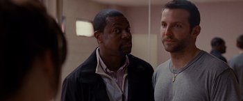 Movie still from “Silver Linings Playbook” (2012), directed by David O. Russell – Two men standing next to each other in a room; Close Up shot, Over the shoulder angle
