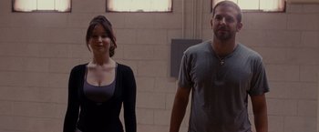 Movie still from “Silver Linings Playbook” (2012), directed by David O. Russell – A man and a woman standing next to each other; Medium shot, Over the shoulder angle