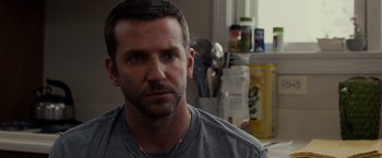 Movie still from “Silver Linings Playbook” (2012), directed by David O. Russell – A person wearing a gray t - shirt; Close Up shot, Over the shoulder angle