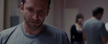 Movie still from “Silver Linings Playbook” (2012), directed by David O. Russell – A person wearing a gray t - shirt; Close Up shot, Over the shoulder angle