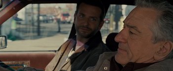 Movie still from “Silver Linings Playbook” (2012), directed by David O. Russell – Two men sitting in the back seat of a car; Close Up shot, Over the shoulder angle