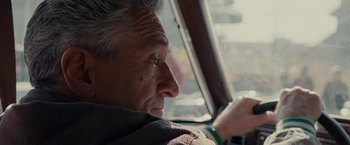 Movie still from “Silver Linings Playbook” (2012), directed by David O. Russell – An older man sitting in the driver's seat of a car; Close Up shot, Over the shoulder angle