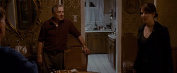 Movie still from “Silver Linings Playbook” (2012), directed by David O. Russell – An older man sitting at a dining room table; Medium shot, Over the shoulder angle