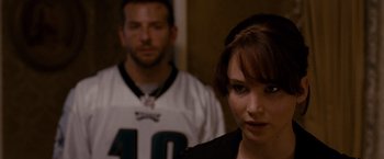Movie still from “Silver Linings Playbook” (2012), directed by David O. Russell – A man and a woman standing next to each other; Close Up shot, Over the shoulder angle