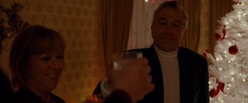 Movie still from “Silver Linings Playbook” (2012), directed by David O. Russell – An older man is holding a glass of water; Medium shot, Over the shoulder angle