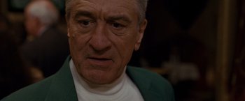 Movie still from “Silver Linings Playbook” (2012), directed by David O. Russell – An older man wearing a white shirt and a green jacket; Close Up shot, Low angle