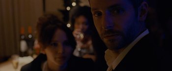 Movie still from “Silver Linings Playbook” (2012), directed by David O. Russell – A group of people that are standing in a room; Close Up shot, Over the shoulder angle