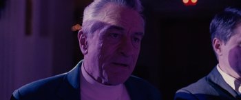 Movie still from “Silver Linings Playbook” (2012), directed by David O. Russell – An older man in a white shirt and a purple jacket; Close Up shot, Over the shoulder angle