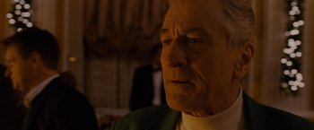 Movie still from “Silver Linings Playbook” (2012), directed by David O. Russell – An older man in a white shirt and a green jacket; Close Up shot, Low angle