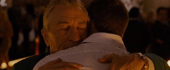 Movie still from “Silver Linings Playbook” (2012), directed by David O. Russell – An older man is hugging a younger man; Close Up shot, Over the shoulder angle