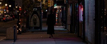 Movie still from “Silver Linings Playbook” (2012), directed by David O. Russell – A person walking down a street at night; Wide shot, Over the shoulder angle