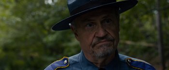 Movie still from “Sinister” (2012), directed by Scott Derrickson – An old man wearing a hat and a uniform; Close Up shot, Over the shoulder angle