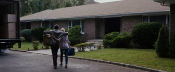 Movie still from “Sinister” (2012), directed by Scott Derrickson – A man and a woman walking down a street; Wide shot, Over the shoulder angle