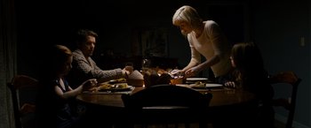 Movie still from “Sinister” (2012), directed by Scott Derrickson – A family sitting at a dinner table eating dinner; Medium shot, High angle