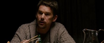 Movie still from “Sinister” (2012), directed by Scott Derrickson – A person holding a bottle of beer and chopsticks; Close Up shot, Over the shoulder angle