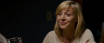 Movie still from “Sinister” (2012), directed by Scott Derrickson – A woman with blonde hair is smiling for the camera; Close Up shot, Over the shoulder angle