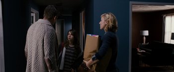 Movie still from “Sinister” (2012), directed by Scott Derrickson – A group of people standing in a room; Medium shot, Over the shoulder angle