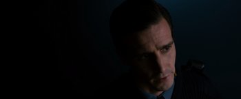 Movie still from “Sinister” (2012), directed by Scott Derrickson – A person wearing a suit and tie; Close Up shot, Low angle
