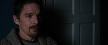 Movie still from “Sinister” (2012), directed by Scott Derrickson – A person in a room; Close Up shot, Over the shoulder angle