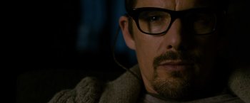 Movie still from “Sinister” (2012), directed by Scott Derrickson – A person wearing glasses; Close Up shot, Over the shoulder angle