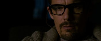 Movie still from “Sinister” (2012), directed by Scott Derrickson – A person wearing glasses; Close Up shot, Over the shoulder angle