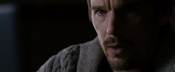 Movie still from “Sinister” (2012), directed by Scott Derrickson – A person wearing a sweater; Close Up shot, Over the shoulder angle