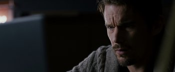 Movie still from “Sinister” (2012), directed by Scott Derrickson – A person wearing a sweater; Close Up shot, Over the shoulder angle