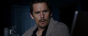 Movie still from “Sinister” (2012), directed by Scott Derrickson – A person wearing a jacket; Close Up shot, Low angle