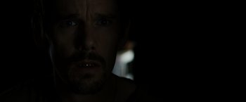Movie still from “Sinister” (2012), directed by Scott Derrickson – A person's face in the dark; Close Up shot, Over the shoulder angle