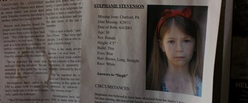 Movie still from “Sinister” (2012), directed by Scott Derrickson – A missing persons poster of stephanie stevenson; Extreme Close Up shot, Overhead angle